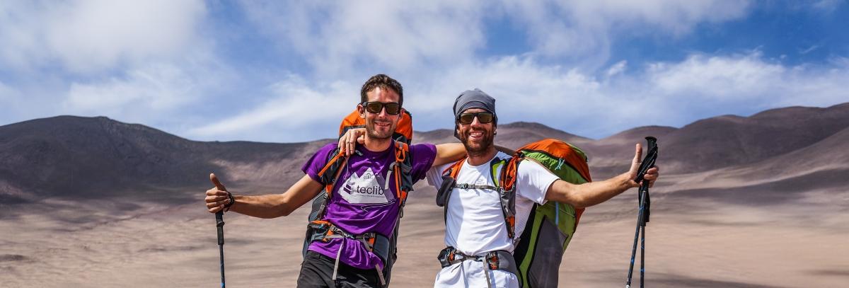 Two people hiking with sunglasses on Two people hiking with sunglasses on
