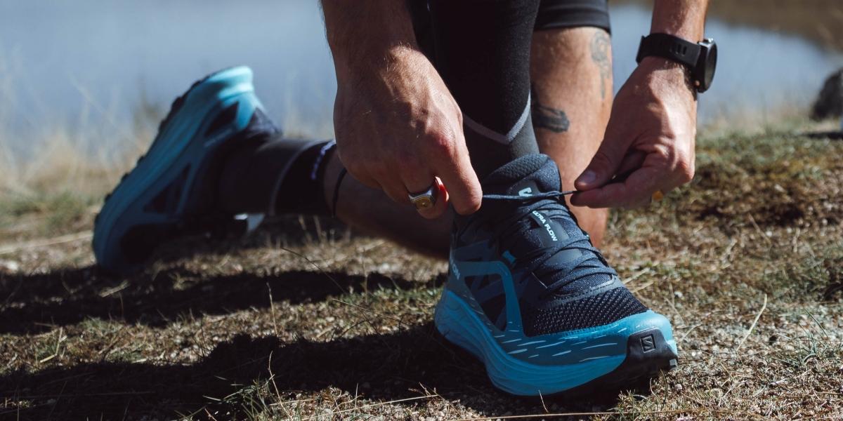 Runner in action on a trail path, close-up on the shoe